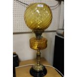A VINTAGE BRASS COLUMN LAMP WITH YELLOW GLASS SHADE AND FONT - H 68 CM