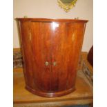 A LATE 19TH CENTURY HANGING BOW FRONTED CORNER CUPBOARD