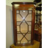 AN EDWARDIAN MAHOGANY INLAID GLAZED HANGING CORNER CABINET