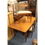 A TEAK EXTENDING DINING TABLE AND FOUR CHAIRS BY A.H. McINTOSH & Co. Ltd. (KIRKALDY, SCOTLAND)