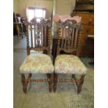A PAIR OF CARVED OAK JACOBEAN STYLE DINING CHAIRS