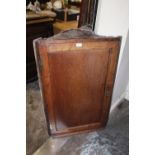 AN ANTIQUE COUNTRYMADE OAK HANGING CORNER CUPBOARD