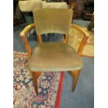 A 1930'S OAK UPHOLSTERED ARMCHAIR