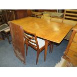 A MID CENTURY 'McINTOSH' EXTENDING TEAK DINING TABLE AND FOUR CHAIRS