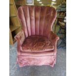 A LARGE VINTAGE UPHOLSTERED TUB TYPE ARMCHAIR