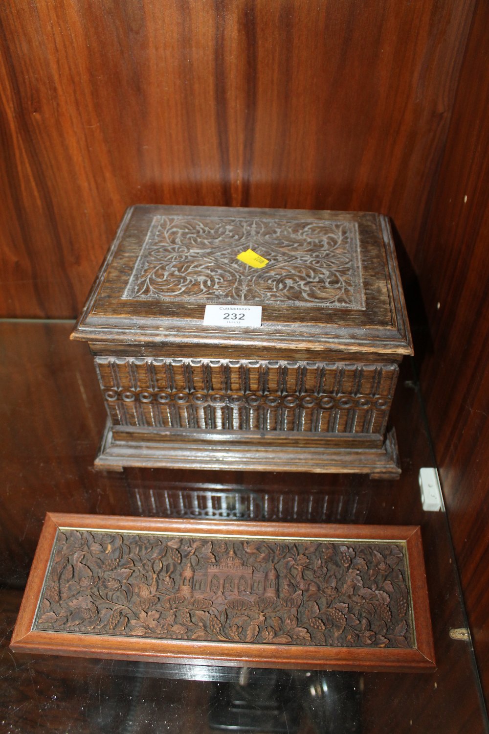 A CARVED OAK LIDDED BOX, TOGETHER WITH AN EASTERN CARVED PANEL DEPICTING THE TAJ MAHAL (2)