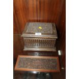 A CARVED OAK LIDDED BOX, TOGETHER WITH AN EASTERN CARVED PANEL DEPICTING THE TAJ MAHAL (2)