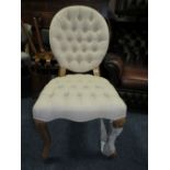 A MODERN UPHOLSTERED BUTTONED BEDROOM CHAIR