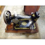 A MAHOGANY CASED SINGER SEWING MACHINE