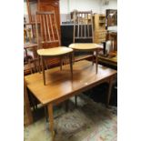 A MID 20TH CENTURY TEAK DRAWLEAF DINING TABLE WITH FOUR CHAIRS