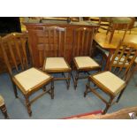 A SET OF FOUR OAK DINING CHAIRS