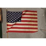 A VINTAGE AMERICAN FLAG - H 59 CM BY W 87 CM, ON POLE