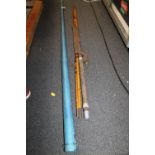 A METAL CASED VINTAGE SNOOKER CUE, TOGETHER WITH A SPLIT CANE FISHING ROD (2)