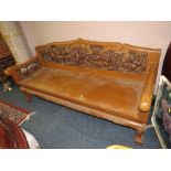 A HEAVILY CARVED HARDWOOD LONG SETTEE, CARVED WITH ELEPHANTS WITHIN A LANDSCAPE, W 175 CM