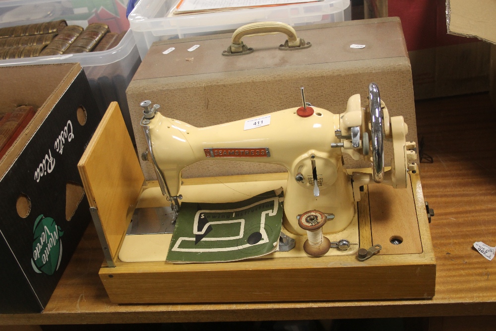 A CASED SEAMSTRESS SEWING MACHINE