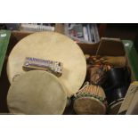 A SELECTION OF MUSICAL INSTRUMENTS TO INCLUDE A BODHRAN, TWO DJEMBE DRUMS, A TAMBOURINE, HARMONICA
