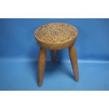 A SIGNED "STAN HOLMAN" MILKING STOOL WITH CELTIC PEN WORK TOP