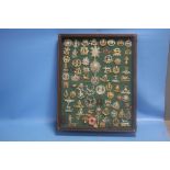 A FRAMED COLLECTION OF CAP BADGES TO INCLUDE SOUTH STAFFS, LEICESTERSHIRE, THE WELSH, THE BUFFS,