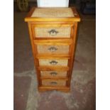 A WICKER AND PINE NARROW FIVE DRAWER CHEST OF DRAWERS