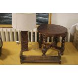 A VINTAGE LEATHER TOPPED TABLE TOGETHER WITH A CARVED WOODEN LAMP AND A BOOK SLIDE