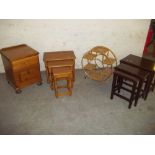 TWO NESTS OF THREE TABLES, A PINE BEDSIDE CABINET AND A WICKER DISPLAY WHEEL STAND (4)