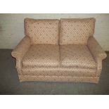 A FABRIC SPRUNG EDGE TWO SEATER SOFA