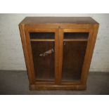 AN OAK TWO DOOR GLAZED BOOKCASE