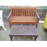 A WOODEN GARDEN BENCH AND A MATCHED TABLE