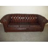 A LEATHER CHESTERFIELD STYLE THREE SEATER SOFA S/D