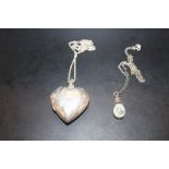 A LARGE STERLING SILVER HEART SHAPED LOCKET ON CHAIN TOGETHER WITH A SILVER AND OPAL PENDANT ON