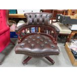 A REPRODUCTION LEATHER SWIVEL OFFICE ARMCHAIR