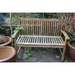 A WOODEN GARDEN BENCH W 114 CM