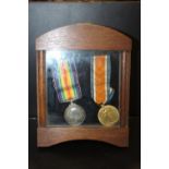 A PAIR OF WWI MEDALS AWARDED TO M-205338 SGT. E.S. CLARKE A.S.C. IN AN OAK GLAZED DISPLAY CASE