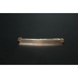 A HALLMARKED 9CT GOLD BAR BROOCH