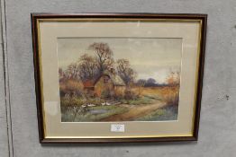 A FRAMED AND GLAZED WATERCOLOUR DEPICTING A COUNTRY COTTAGE WITH DUCKS 24CM X 34CM
