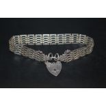 A STERLING SILVER GATE BRACELET WITH HALLMARKED SILVER HEART LOCK