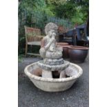 A CONCRETE GARDEN FOUNTAIN IN THE FORM OF A BOY BLOWING HIS HORN H 84 CM
