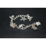 A STERLING SILVER CHARM BRACELET WITH EIGHT CHARMS