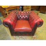 AN OXBLOOD CHESTERFIELD TYPE CHAIR A/F
