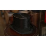A BATTERSBY & Co. OF LONDON BLACK SILK TOP HAT, THE INTERIOR LINED WITH CREAM SILK AND BLACK PRINTED