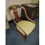A VICTORIAN MAHOGANY ROCKING CHAIR WITH UPHOLSTERED SEAT