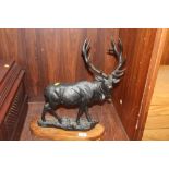 A LARGE BRONZED METAL FIGURE OF A STAG MOUNTED ON A WOODEN PLINTH