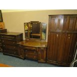 AN OAK LINENFOLD THREE PIECE BEDROOM SUITE COMPRISING A 4 DRAWER CHEST, DRESSING TABLE AND