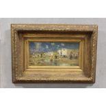 A GILT FRAMED OIL ON BOARD BEACH SCENE WITH FIGURES BEACH HUT CARTS - H 19 CM BY 39 CM