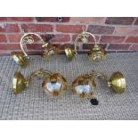 A SET OF FOUR BRASS EFFECT WALL LIGHT FITTINGS WITH RETRO GLASS SHADES