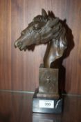 A MODERN BRONZED METAL FIGURE OF A MYTHICAL STYLE HORSES HEAD RAISED ON A MARBLE PLINTH