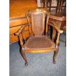A VINTAGE MAHOGANY AND BERGERE ARMCHAIR