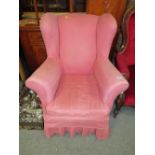 A VINTAGE PINK UPHOLSTERED WINGBACK ARMCHAIR