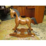 A MODERN CARVED HARDWOOD ROCKING HORSE OF SMALL PROPORTIONS