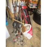 A BAG OF GOLF CLUBS TOGETHER WITH A GOLF TROLLEY PLUS SPARE WHEEL, HOCKEY STICKS ETC